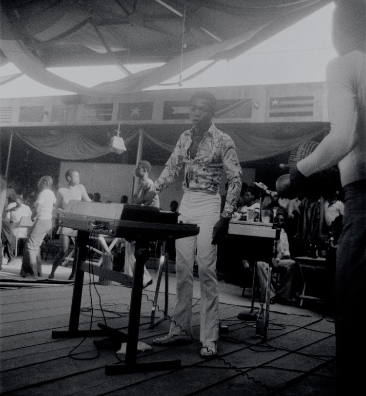 fela kuti plays keyboard on stage shrine lagos with boys in background