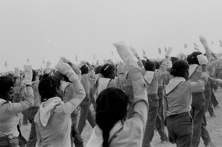 girls in uniform marching with raised fists polisario ten year celebration western sahara 1986