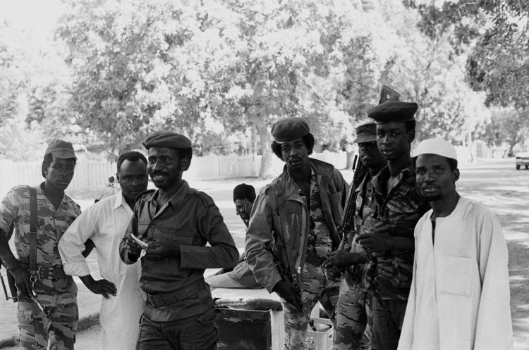 five chadian soldiers and two civilian men look towards camera ndjamena street 1982