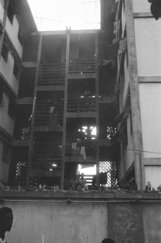 tenement building in lagos nigeria 1978 with light shining through and the sky