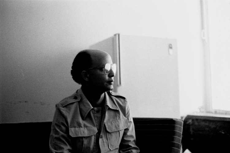 seated man in profile big glasses sahara 1986