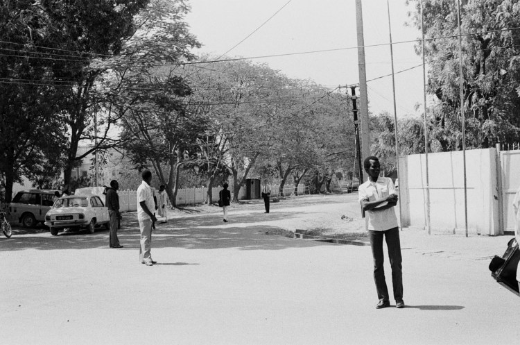 five men in the street with telegraph poles ndjamena 1982