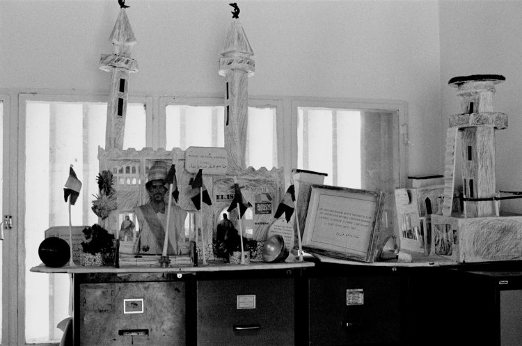model building with minarets and effigy and miniature flags on filing cabinet chad 1982