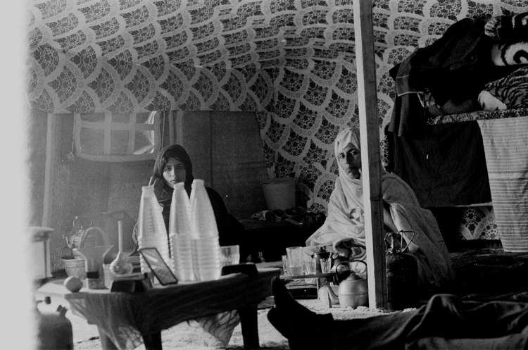 two women in tent with bottled water western sahara